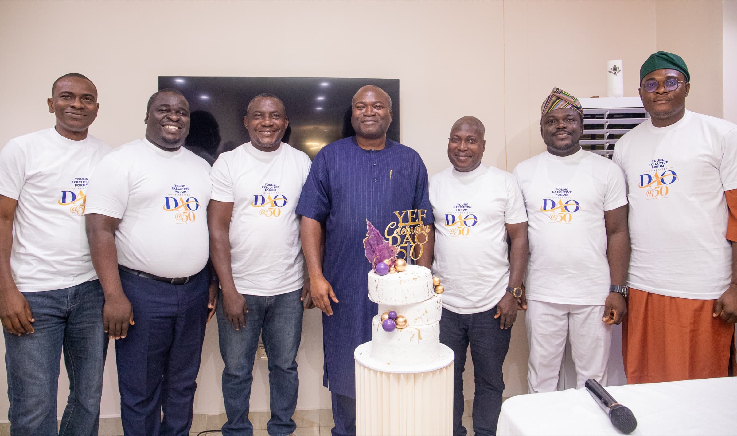 Dr. Ogunsan with Young Executive Forum members beside the DAO @50 cake
